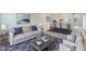 Cozy living room featuring stylish decor, a comfortable sofa, and a dining area with modern furnishings at 1230 Americana Pl, Orlando, FL 32807