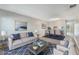 Inviting living room with stylish decor, a comfortable sofa, and an open dining area at 1230 Americana Pl, Orlando, FL 32807