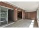 Porch with brick accents and sliding glass doors to kitchen at 1230 Americana Pl, Orlando, FL 32807