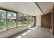 Porch with many windows overlooking backyard at 1230 Americana Pl, Orlando, FL 32807
