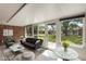 Bright sunroom with brick accent wall and lots of natural light at 1230 Americana Pl, Orlando, FL 32807