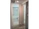 Bright bathroom featuring gray floors, marble tile walls, and a sliding door mirrored closet at 1250 S Denning Dr # 108, Winter Park, FL 32789