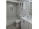 Bathroom features a tub with marble tile surround, matching sink with cabinet, and an overhead cabinet at 1250 S Denning Dr # 108, Winter Park, FL 32789