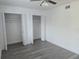 Bright bedroom featuring wood-look floors, two closets and neutral decor at 1250 S Denning Dr # 108, Winter Park, FL 32789