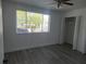 Cozy bedroom with a ceiling fan and view through a large window at 1250 S Denning Dr # 108, Winter Park, FL 32789