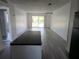 Spacious living room featuring sleek floors and sliding glass doors leading to the outside at 1250 S Denning Dr # 108, Winter Park, FL 32789