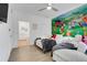 Charming themed bedroom with twin beds, playful wall art and an ensuite bathroom at 1375 Tuscana Ln # 1102, Davenport, FL 33896
