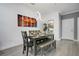 Bright dining room features modern light fixture, beautiful wall art, and stylish gray wood flooring at 1375 Tuscana Ln # 1102, Davenport, FL 33896