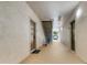 Hallway showing apartment entrance doors and a staircase with neutral walls and flooring at 1375 Tuscana Ln # 1102, Davenport, FL 33896
