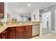 Open kitchen with granite countertops and stainless steel dishwasher overlooking living space at 1375 Tuscana Ln # 1102, Davenport, FL 33896