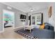 Comfortable living room featuring modern decor, tv and easy access to an adjacent bedroom at 1375 Tuscana Ln # 1102, Davenport, FL 33896