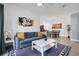 Open-concept living room adjacent to dining area, featuring comfortable seating and stylish decor at 1375 Tuscana Ln # 1102, Davenport, FL 33896