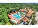 Gorgeous resort style pool with cabanas, a splash pad, lounge chairs, and lush tropical landscaping at 1375 Tuscana Ln # 1102, Davenport, FL 33896