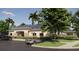 Beige clubhouse with stone accents, dark shutters, and a well-maintained parking area at 1435 Acorn Meadow Loop, Eustis, FL 32726