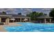 Sparkling blue pool with covered seating area, perfect for relaxation and leisure at 1435 Acorn Meadow Loop, Eustis, FL 32726
