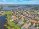 Aerial view showcasing a residential neighborhood near a lake, featuring beautiful houses, green spaces, and waterfront scenery at 14357 United Colonies Dr, Winter Garden, FL 34787