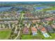 An aerial view of the community with a lake in the background and neatly arranged residential houses at 14357 United Colonies Dr, Winter Garden, FL 34787