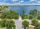 Aerial view of a street ending at a lake with a dock and trees surrounding the area at 14357 United Colonies Dr, Winter Garden, FL 34787