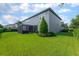 Expansive backyard featuring lush green grass, a screened-in patio, and manicured landscaping at 14357 United Colonies Dr, Winter Garden, FL 34787