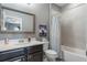 Bathroom featuring a vanity with a sink, framed mirror, and bathtub with a shower, offering a tranquil retreat at 14357 United Colonies Dr, Winter Garden, FL 34787