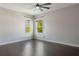Bright bedroom with hardwood floors and two windows letting in natural light at 14357 United Colonies Dr, Winter Garden, FL 34787
