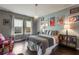 Charming bedroom with hardwood floors, stylish decor, and plenty of natural light from the large windows at 14357 United Colonies Dr, Winter Garden, FL 34787