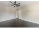 Spacious bedroom featuring dark hardwood floors, neutral paint, and a ceiling fan at 14357 United Colonies Dr, Winter Garden, FL 34787