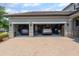 Spacious three-car garage with stone accents and ample storage for vehicles and equipment at 14357 United Colonies Dr, Winter Garden, FL 34787