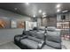 Home theater with tiered seating, projector, movie shelves, and custom decor, perfect for entertainment at 14357 United Colonies Dr, Winter Garden, FL 34787