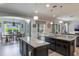 Modern kitchen with granite countertops, stainless steel appliances, and adjacent dining area at 14357 United Colonies Dr, Winter Garden, FL 34787