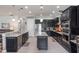 A modern kitchen featuring stainless steel appliances, dark cabinetry, and pendant lighting at 14357 United Colonies Dr, Winter Garden, FL 34787