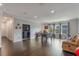 Large living room featuring dark hardwood floors, neutral walls, and a foosball table for Gathering entertainment at 14357 United Colonies Dr, Winter Garden, FL 34787