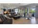 Open-concept living room with tile flooring and access to a screened-in lanai at 14357 United Colonies Dr, Winter Garden, FL 34787