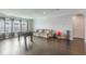 Spacious living room with dark hardwood floors, neutral walls, and a cozy sofa, perfect for relaxation at 14357 United Colonies Dr, Winter Garden, FL 34787