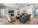 Bright living room with sleek seating arrangements, a modern ceiling fan and wood-look tile floors at 14357 United Colonies Dr, Winter Garden, FL 34787