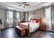 Charming main bedroom with a wooden bed frame, a ceiling fan and a window view at 14357 United Colonies Dr, Winter Garden, FL 34787