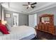 Beautiful main bedroom featuring dark wood floors, tray ceiling, and stylish furniture at 14357 United Colonies Dr, Winter Garden, FL 34787
