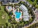 Aerial view of a community pool with lounge chairs, splash pool, and covered seating area at 14357 United Colonies Dr, Winter Garden, FL 34787