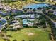 Community pool area featuring a clubhouse, swimming pool, lounge seating, and a scenic view of the lake at 14357 United Colonies Dr, Winter Garden, FL 34787