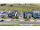 Aerial view of a home on a tree-lined street featuring well-maintained landscaping and a two-car garage at 16055 Silver Brook Way, Winter Garden, FL 34787