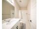 Bright bathroom with a single vanity, neutral tile, and bathtub with shower at 16055 Silver Brook Way, Winter Garden, FL 34787