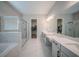 Elegant bathroom with a glass-enclosed shower, dual sinks, and a walk-in closet at 16055 Silver Brook Way, Winter Garden, FL 34787