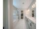 Beautiful bathroom featuring double sinks, soaking tub, glass shower, and walk-in closet at 16055 Silver Brook Way, Winter Garden, FL 34787