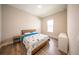 Bedroom with wood flooring, window, bed with blue accents and a side table at 16055 Silver Brook Way, Winter Garden, FL 34787