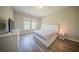 Bright bedroom featuring wood floors, large windows, and contemporary white furniture at 16055 Silver Brook Way, Winter Garden, FL 34787