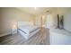 Modern bedroom with white platform bed, wood-look flooring, and a sleek minimalist design at 16055 Silver Brook Way, Winter Garden, FL 34787