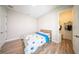 Bright bedroom featuring wood floors, closet, and a cozy bed with fun, colorful bedding at 16055 Silver Brook Way, Winter Garden, FL 34787