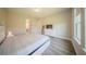 A bedroom with wood floors, and bed next to the door leading to the bathroom at 16055 Silver Brook Way, Winter Garden, FL 34787