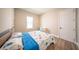 Bedroom showcasing wood flooring, a bed with blue accents and natural light at 16055 Silver Brook Way, Winter Garden, FL 34787