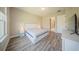 Modern bedroom with wood floors and an ensuite bathroom view, bathed in natural light at 16055 Silver Brook Way, Winter Garden, FL 34787